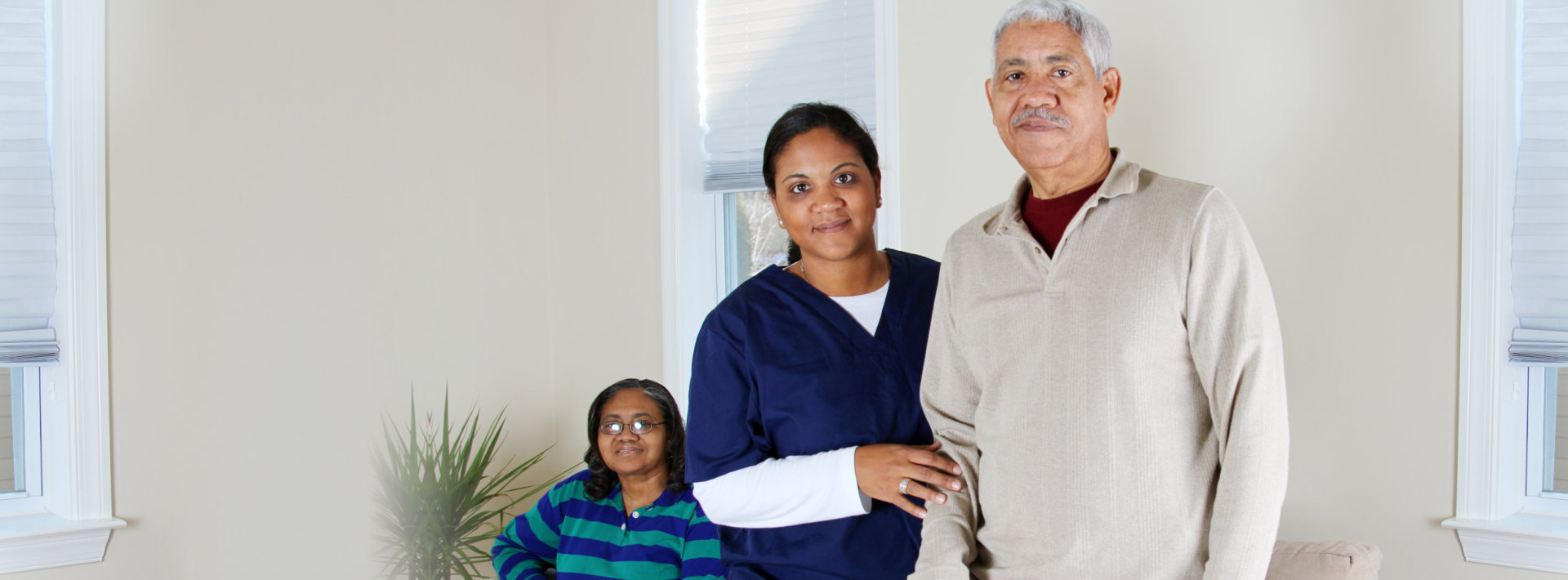 caregiver and senior couple smiling