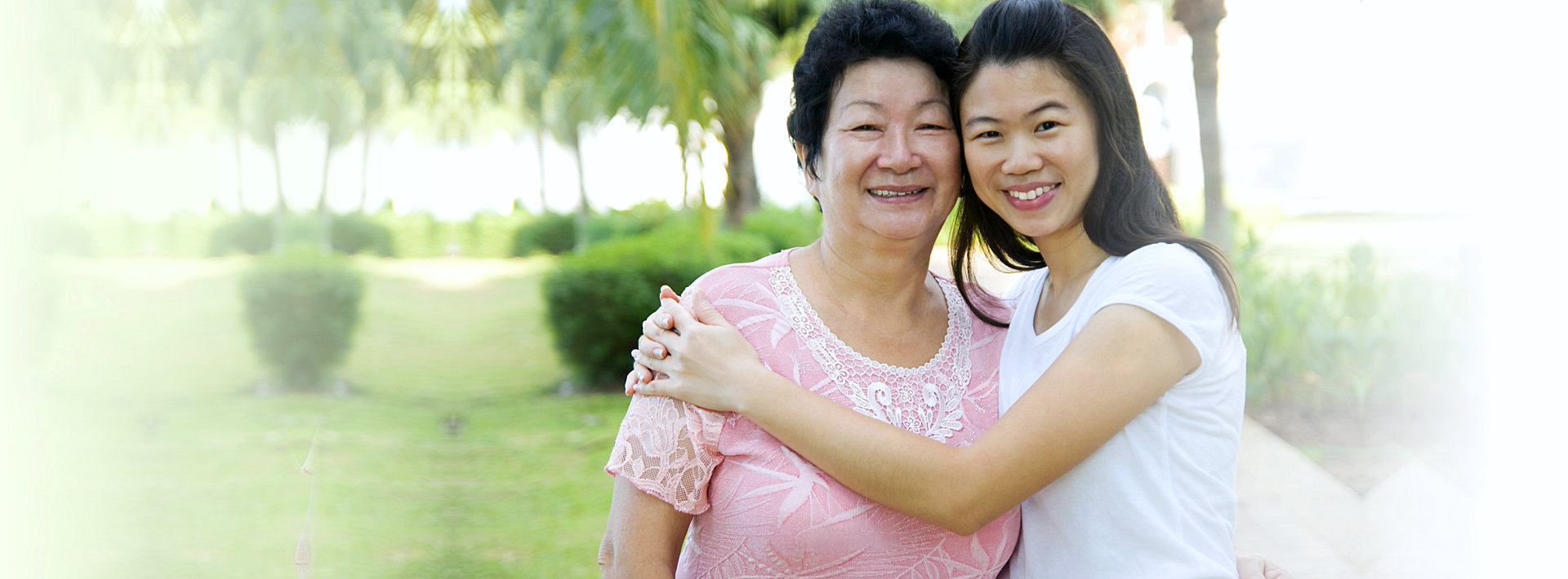 female caregiver and senior woman smiling